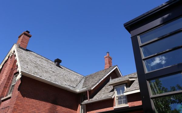 Black modern addition on heritage brick